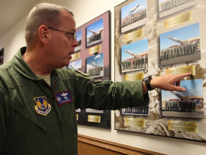 Colonel Charles Webb walks down the hallways lined with class photos dating back to the school’s founding in 1944. 