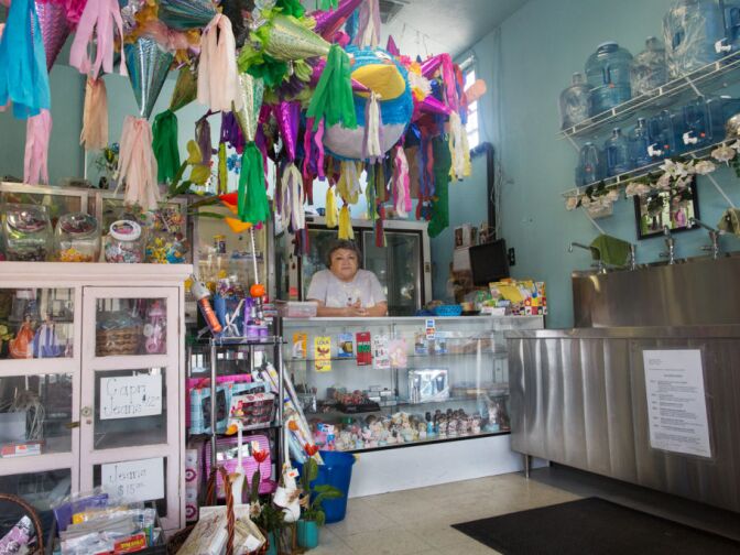 Lilia Perera and her husband own Agua Pura, a store that sells water and gifts across the street from the site of the future Walmart. The couple worries that they won't be able to compete with Walmart's low prices.
