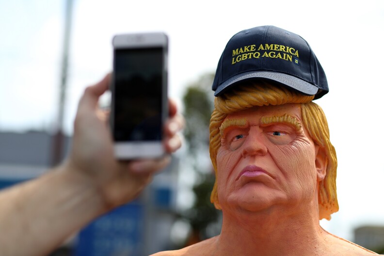 AUGUST 18:  A man takes his picture with a statue depicting Republican presidential nominee Donald Trump in the nude in San Francisco. Anarchist collective INDECLINE has created five statues and placed them in five U.S. cities: San Francisco, New York, Los Angeles, Cleveland and Seattle.