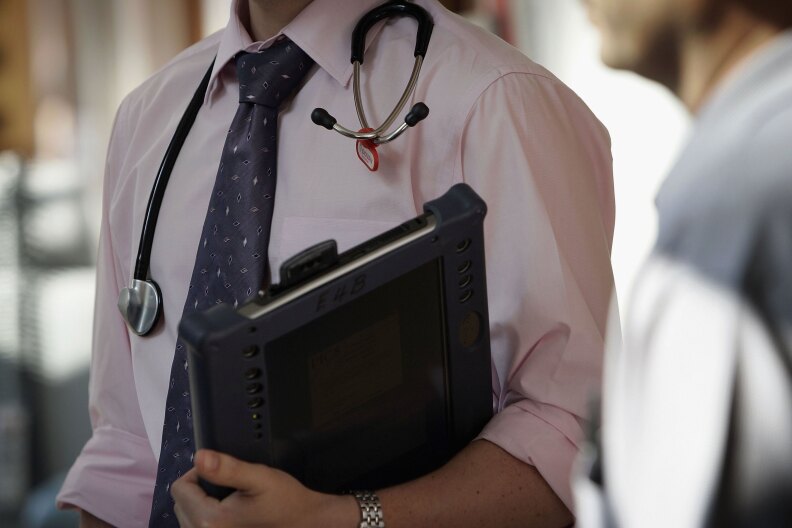 BIRMINGHAM, UNITED KINGDOM - JUNE 14: A doctor at The Queen Elizabeth Hospital Birmingham does his rounds on the wards on June 14, 2006 in Birmingham, England. Senior managers of the NHS have said that the organisation needs to become more open in the future. 