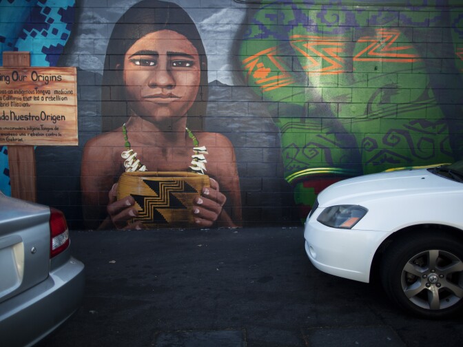 A mural of an indigenous person brightens a wall in a gas station along Van Nuys Boulevard in Pacoima.
