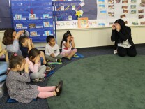 Teacher Cathy Barraza sings a song and acts out the motions with preschoolers at Educare Los Angeles, Long Beach.