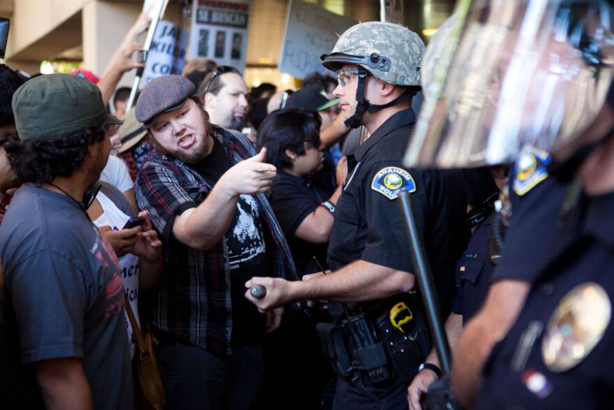 ANAHEIM, CA - JULY 24: Protesters clash with police at Anaheim City Hall to show their outrage for the shooting death of Manuel Angel Diaz, 25, on July 24, 2012 in Anaheim, California. Diaz was fatally shot July 21 by an Anaheim police officer and has sparked days of protests by the angered community. (Photo by Jonathan Gibby/Getty Images)