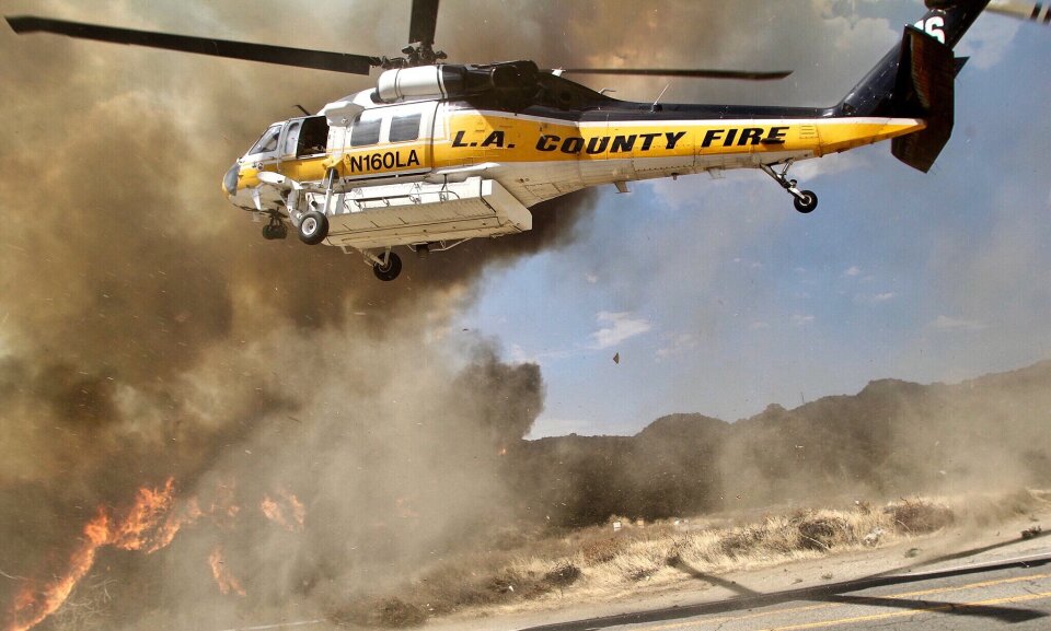 A helicopter from the L.A. County Fire Department provides air support to crews battling the La Tuna Fire burns in the hills above Burbank on September 2, 2017.