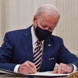 US President Joe Biden signs executive orders for economic relief to Covid-hit families and businesses in the State Dining Room of the White House in Washington, DC, on January 22, 2021. (Photo by Nicholas Kamm / AFP) (Photo by NICHOLAS KAMM/AFP via Getty Images)