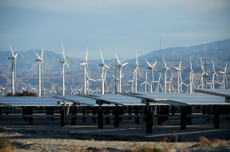 Giant wind turbines are powered by strong winds in front of solar panels on March 27, 2013 in Palm Springs, California. According to reports, California continues to lead the nation in green technology and has the lowest greenhouse gas emissions per capita, even with a growing economy and population.   