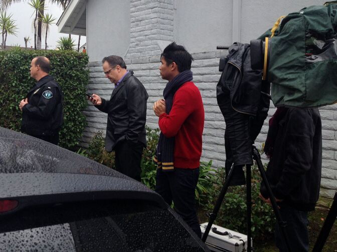 Members of the media wait across the street from Christopher Dorner's La Palma home on Friday morning, where authorities are carrying out a search warrant in connection to a homicide investigation.