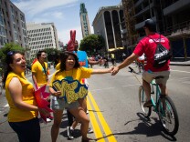 CicLAvia volunteers encourage riders at the Koreatown Hub of CicLAvia on June 23, 2013.