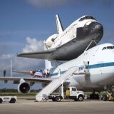 In this handout provided by NASA, Workers pose for a photograph on the wing of NASA's Shuttle Carrier Aircraft, or SCA, with the space shuttle Endeavour mated on top, at the NASA Kennedy Space Center, Shuttle Landing Facility on Sept. 18, 2012 in Cape Canaveral, Florida.