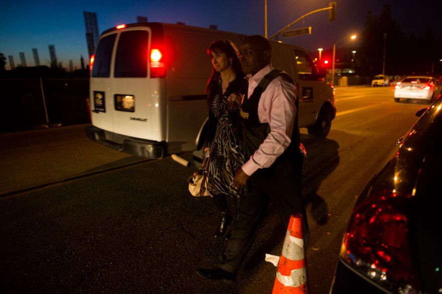 A Sheriff and another woman mourn the loss of a San Bernardino Sheriff's Deputy at Loma Linda Hospital.