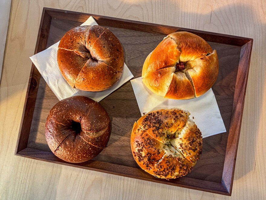 Four Taiwanese-style bagels arranged on a wooden tray at Miopane in Pasadena.