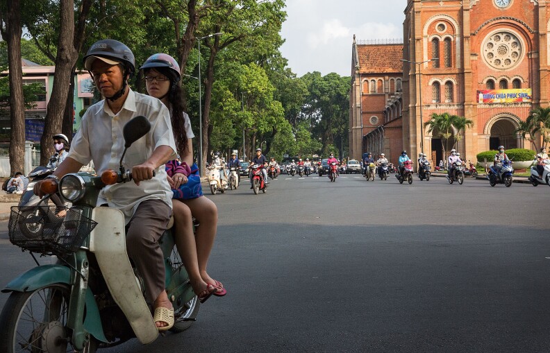 HO CHI MINH CITY, VIETNAM - APRIL 21:  Motorists pass by the Saigon Notre-Dame Basilica on April 21, 2015 in Ho Chi Minh City, Vietnam.  April 30th marks the 40th anniversary of the capture of Saigon by North Vietnamese forces.  (Photo by Taylor Weidman/Getty Images)