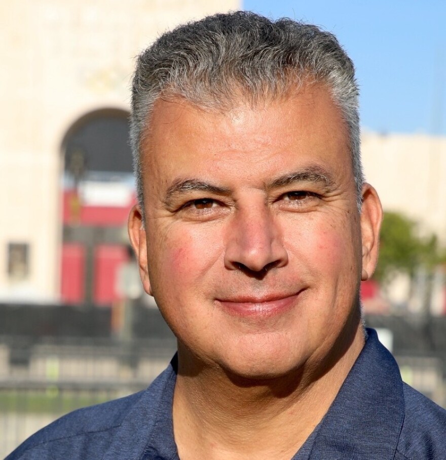 A close-up image of Retired L.A. Sheriff’s Captain Matt Rodriguez. He is wearing an open-collared blue shirt and he has salt-and-pepper hair.
