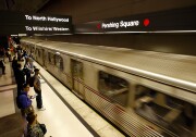 Passengers board a Metro Red Line train during rush hour. 