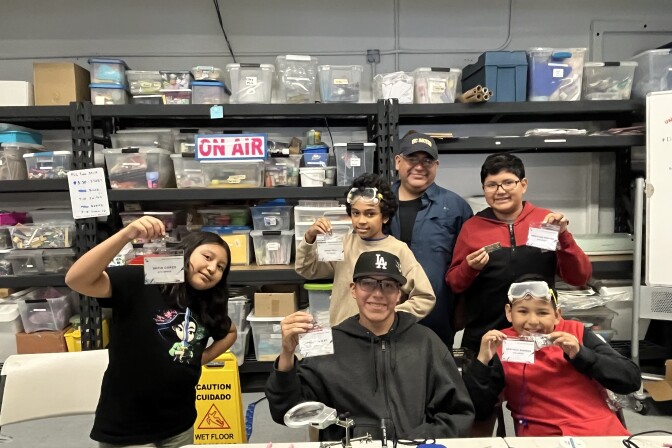 A group of kids show off their home-made ham radios.