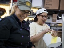 Grub co-owner Betty Fraser, left, and server Sylvia Quintanilla prepare boxes for next day's catering lunch order on Wednesday, June 10, 2015 at Grub's catering kitchen in Hollywood.