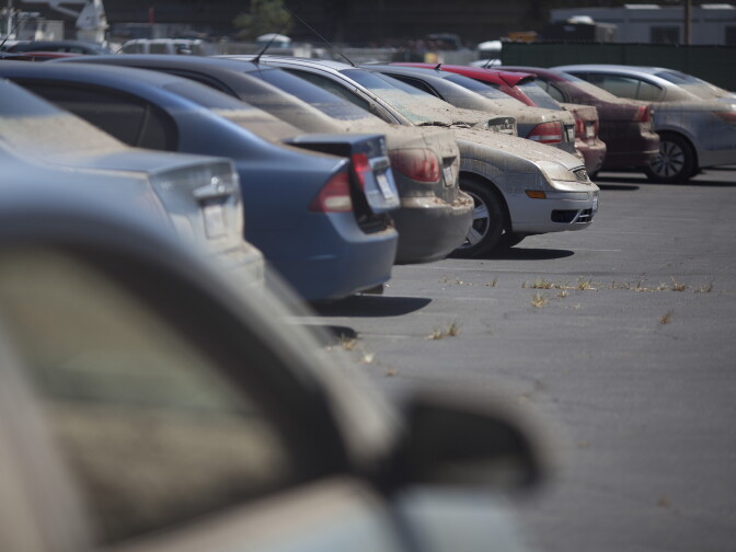 Cars considered a total loss from the UCLA flood are lined in a parking lot near Jackie Robinson Stadium.