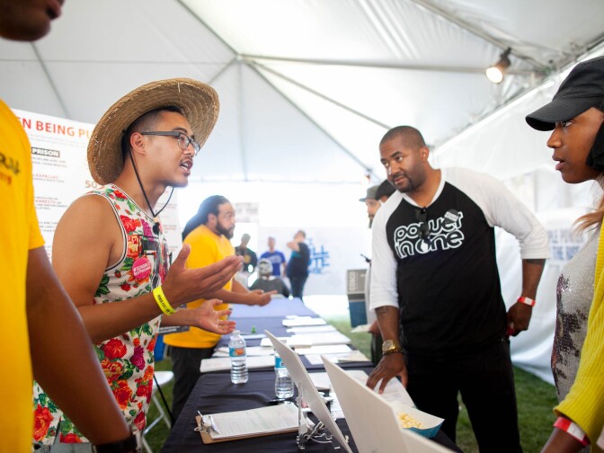 Matthew Vu (left) talks to local residents about issues that will be on the ballot during the 5th annual Power Fest Music and Art Festival in Martin Luther King Jr. Park on Saturday, Sept. 3, 2016.