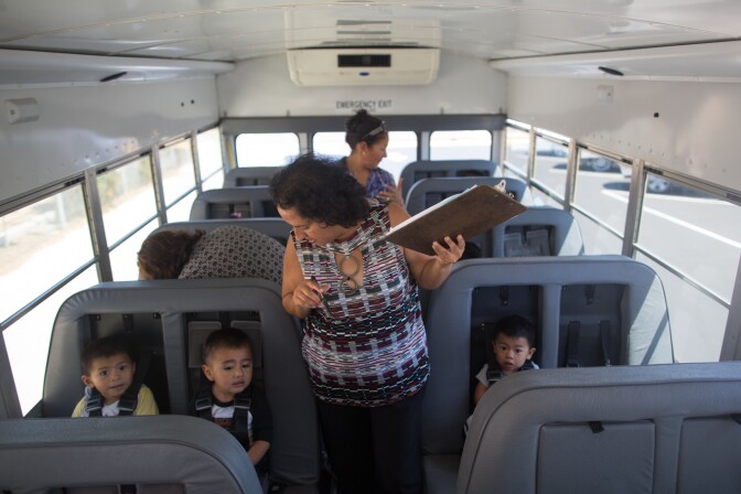Bertha Villarreal, the bus driver for the Encanto Migrant and Seasonal Headstart, and Elsa Ramirez, take attendance on the bus that will take children home around Oxnard.