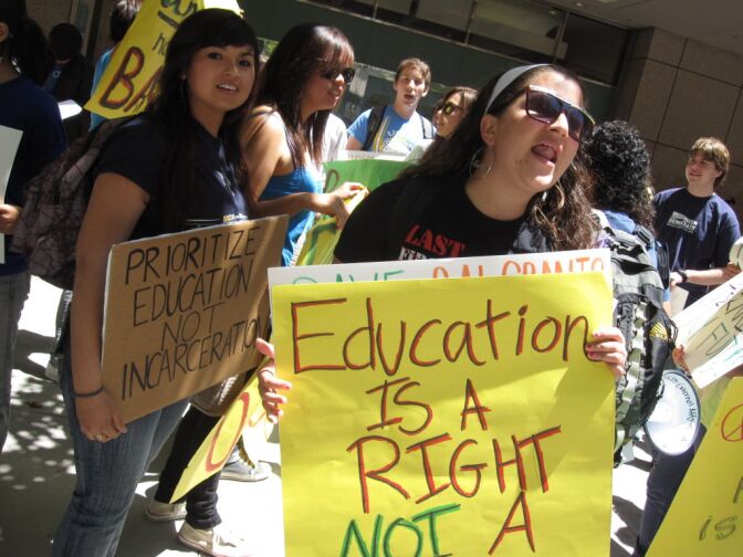 UC San Diego ethnic studies major Diana Spix, right, rallies in support of continued state funding for Cal Grants.