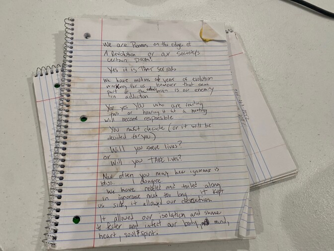 A spiral paper notebook with coffee stains that Jami uses to write her thoughts in while in drug treatment.