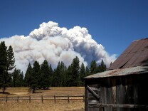 YOSEMITE NATIONAL PARK, CA - AUGUST 22:  Smoke from the Rim Fire is visible near the Hetch Hetchy reservoir on August 22, 2013 in Yosemite National Park, California. The Rim Fire continues to burn out of control and threatens 2,500 homes outside of Yosemite National Park. Over 1,000 firefighters are battling the blaze that was reduced to only 2 percent containment after it nearly tripled in size overnight.  (Photo by Justin Sullivan/Getty Images)