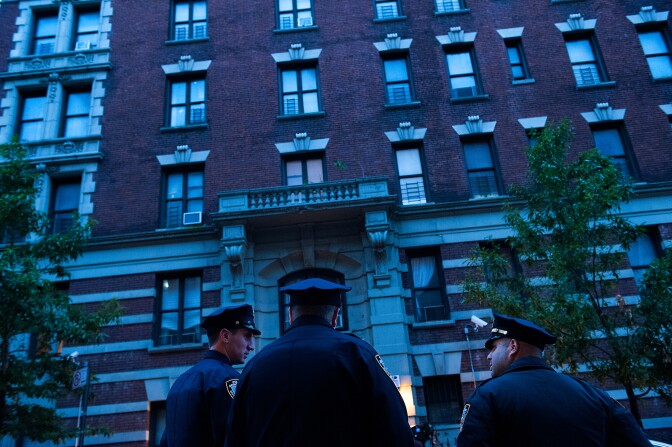 Police officers stand outside 546 W. 147th street, the apartment building of Dr. Craig Spencer, Oct. 23, 2014 in New York City. After returning to New York City from Guinea where he was working with Doctors Without Borders treating Ebola patients, Spencer was quarantined after showing symptoms consistent with the virus. Spencer was taken to Bellevue hospital to undergo testing.