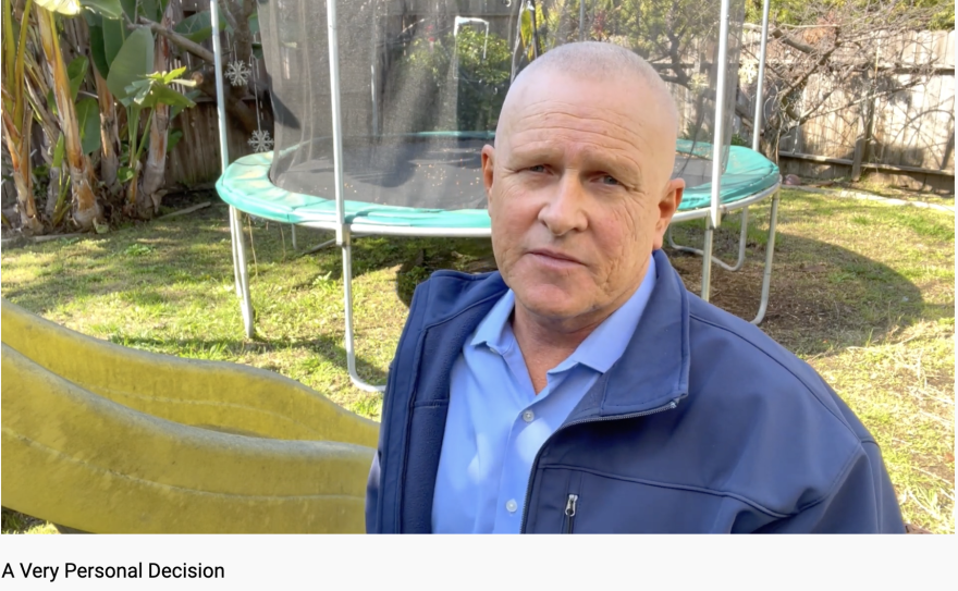 In a screenshot from a YouTube video titled 'A Very Personal Decision,' LA City Councilman Mike Bonin stands in a backyard wearing a blue jacket and lighter blue shirt. A trampoline with protective netting is in the yard behind him.