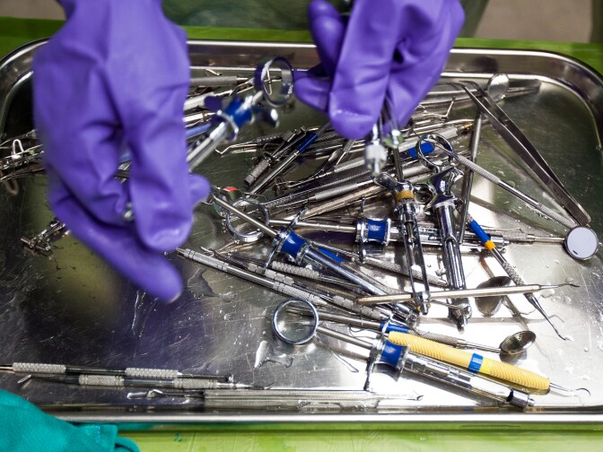 Dental assistants clean instruments during Care Harbor's annual Los Angeles medical clinic at the Los Angeles Memorial Sports Arena on Thursday, Oct. 31.