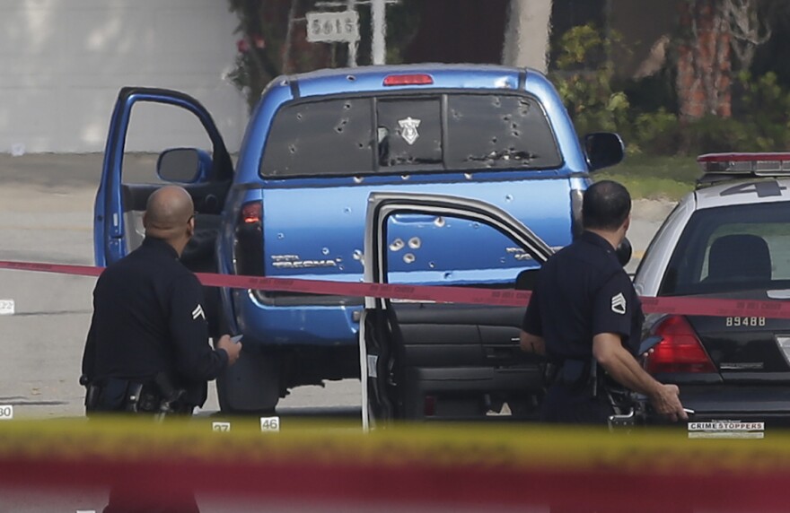 FILE - This Feb. 7, 2013 file photo law enforcement officers look over the scene of an officer involved shooting in Torrance, Calif. An attorney says two women won't take a truck they were offered to replace one shot up by Los Angeles police during the hunt for rogue ex-cop Christopher Dorner. Margie Carranza and her 71-year-old mother were delivering newspapers in Torrance last month when police mistook their truck for Dorner's and riddled it with bullets. Carranza was hit by broken glass and her mother, Emma Hernandez, was shot twice in the back. (AP Photo/Chris Carlson,File)