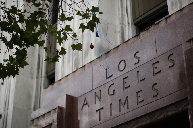 LOS ANGELES, CA - JULY 10:  Deflated balloons hang from a tree outside the entrance to the Los Angeles Times building after the Tribune Co. announced that it wants to split its broadcasting and publishing businesses into two companies on July 10, 2013 in Los Angeles, California. The new Tribune Publishing Co. would own the Los Angeles Times, the Chicago Tribune and six other daily papers. In addition the those newspapers, the Chicago-based Tribune currently owns 23 TV stations, including KTLA-TV, cable network WGN America.  (Photo by David McNew/Getty Images)
