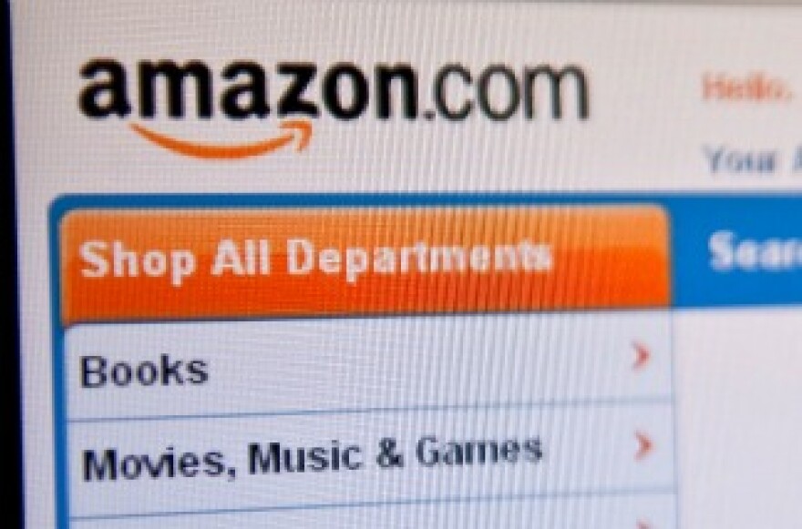 The Amazon homepage appears on a computer screen.