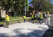 Street crews lay down a new type of reflective seal on a stretch of road in Canoga Park. 