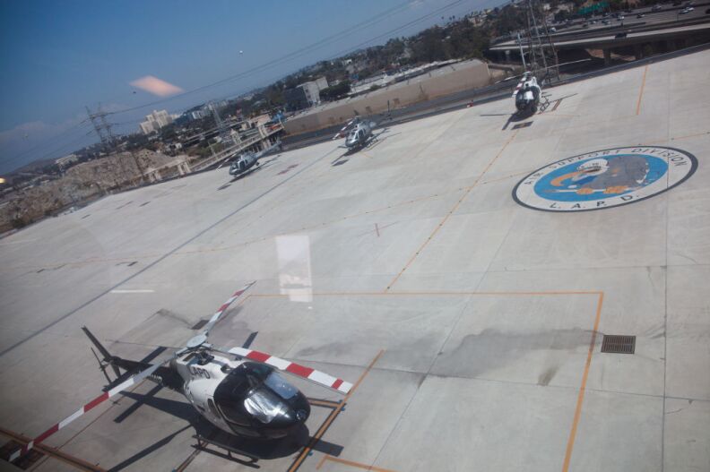Helicopters parked on the tarmac on the top floor of a facility near the Men's Central Jail in downtown Los Angeles. Anyone who steps on the squadron's logo has to do 50 pushups.