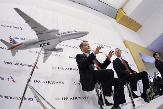 DALLAS, TX -  FEBRUARY 14:  Doug Parker (L), Chairman and CEO of US Airways, and Thomas Horton, Chairman, President and Chief Executive Officer of American Airlines speak during a news conference to announce the merger of the two airlines February 14, 2013 in Dallas Texas. US Airways and American Airlines have agreed to an $11 billion merger, creating the largest airline in the world. The airline will be called American Airlines and be headed by US Airways CEO Doug Parker.  (Photo by Donna McWilliam/Getty Images