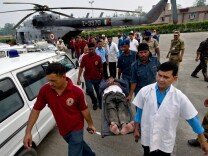 An Indian pilgrim, evacuated from flood-hit areas by the Indian Air Force, is transported on a stretcher by medics at the Jolly Grant Airport in Dehradun, state capital of Uttarakhand on June 21, 2013. Rescue workers recovered scores of bodies from the Ganges river in northern India on June 21, as the death toll from flash floods and landslides topped 500, with thousands of mainly pilgrims and tourists still stranded.  (Photo: MANAN VATSYAYANA/AFP/Getty Images)