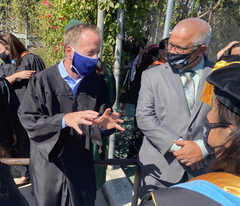 L.A. Unified School District Superintendent Austin Beutner (left) speaks with staff before the Belmont High School graduation ceremony on June 11, 2021.