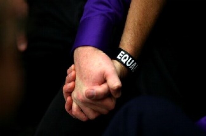 A same-sex couple hold hands during a sit-in protest when same-sex couples were denied marriage licenses from the San Francisco county clerk on February 14, 2011 in San Francisco, California.
