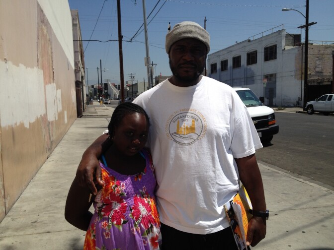 Umar Hakim and 8 year-old daughter, Aneesah, distributing flyers for Humanitarian Day on August 12th, in downtown Los Angeles.