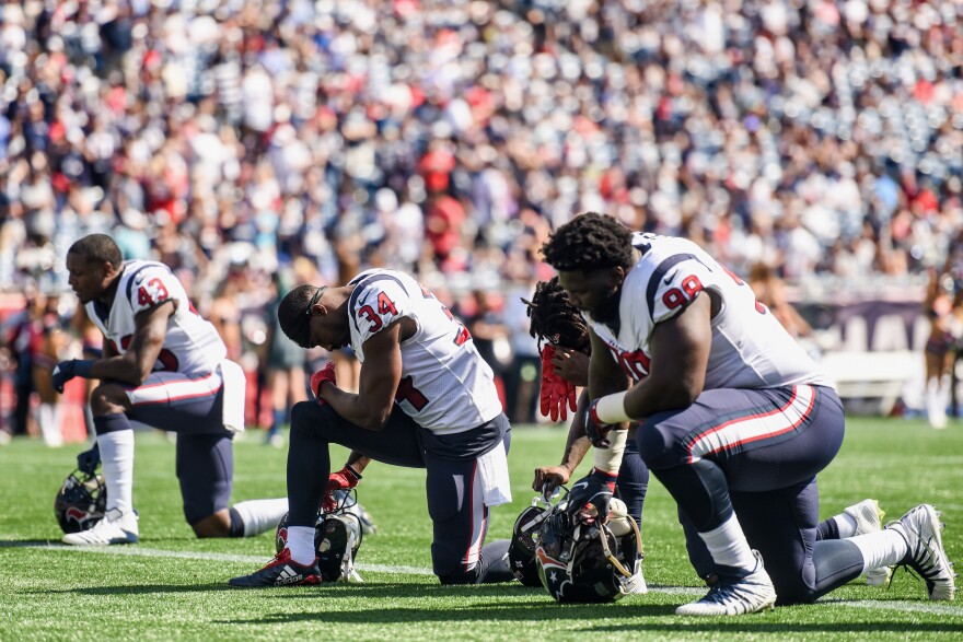 FOXBORO, MASSACHUSETTS - SEPTEMBER 24:  Members of the Houston Texans kneel before a game against the New England Patriots at Gillette Stadium on September 24, 2017 in Foxboro, Massachusetts.  (Photo by Billie Weiss/Getty Images)