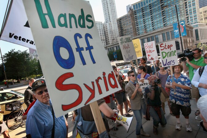 Demonstrators protest against military intervention in Syria outside President Barack Obama’s national campaign headquarters on June 26, 2012 in Chicago, Illinois. The protest, organized by a coalition of anti-war groups, was held today to coincide with an emergency meeting NATO was holding to consider military action in Syria.
