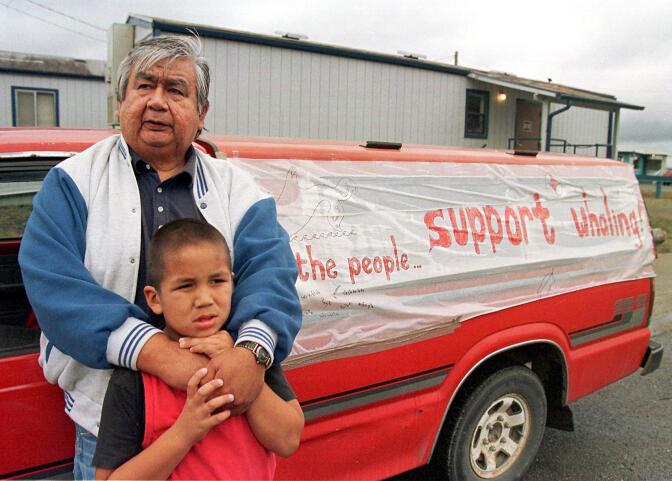 NEAH BAY, UNITED STATES:  Makah Native Americans Dewey Johnson (top) and his son, Michael, 6-year-old, show their support in Neah Bay, WA 01 October for fellow tribe members in their quest to hunt gray whales for the first time in 70 years.  The Makah are planning to hunt the whales from traditional canoes in October.               AFP PHOTO/Dan Levine (Photo credit should read DAN LEVINE/AFP via Getty Images)
