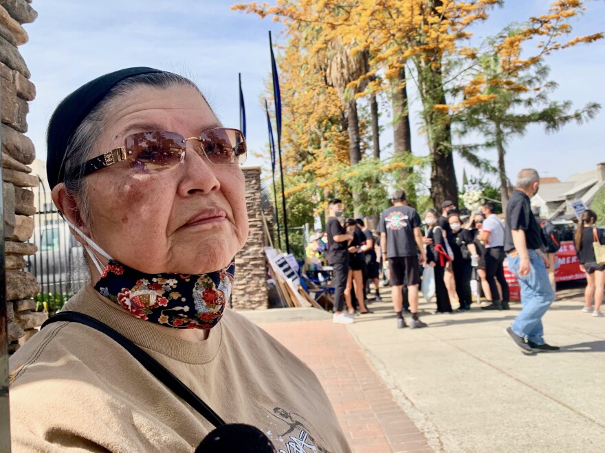 Ida Kawasaki, whose aunt lives at the Sakura Gardens nursing home, stands at a recent protest outside the facility.