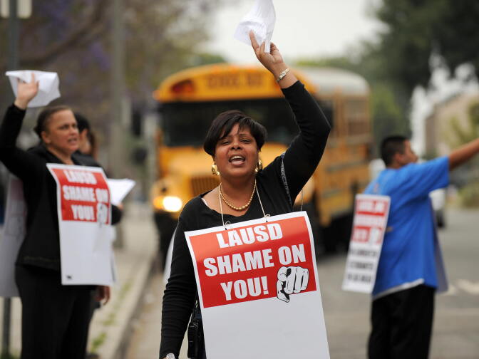 Teachers, parents, supporters and students chant slogans on a picket line outside Crenshaw High School to protest  teacher layoffs planned by the Los Angeles Unified School District (LAUSD)  in Los Angeles, California on May 15, 2009.  California  Governor Arnold Schwarzenegger unveiled yesterday a state budget proposal which called for $9 billion in cuts, of which as much as $5 billion could come from school spending.   AFP PHOTO / ROBYN BECK (Photo credit should read ROBYN BECK/AFP/Getty Images)