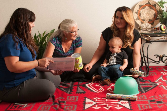 Jaclyn Gray, left, project coordinator for the Riverside‐San Bernardino County Indian Health Home Visiting Program, visiting a family in Riverside County.