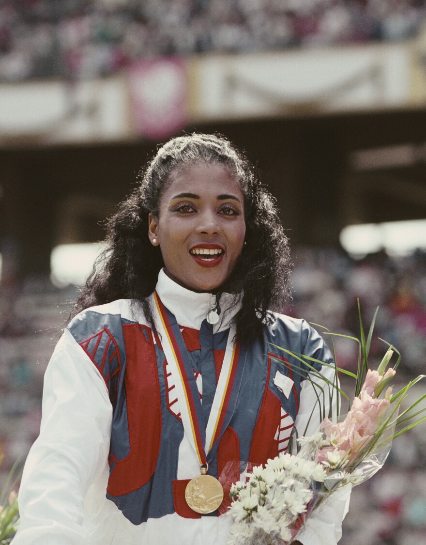 Florence Griffith-Joyner celebrates with her gold medal after winning the Women's 100 meters final event during the 1988 Summer Olympic Games in Seoul, South Korea.