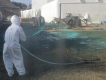 Workers at the Fukushima Dai-ichi nuclear power plant spray a substance to help reduce dust in 2012. Japanese government regulators said Wednesday that for the first time they will conduct their own investigation into the country's nuclear crisis to address key unanswered questions.The March 2011 earthquake and tsunami cut power and destroyed vital cooling systems at the Fukushima Dai-chi nuclear plant, causing meltdowns at three of its reactors.