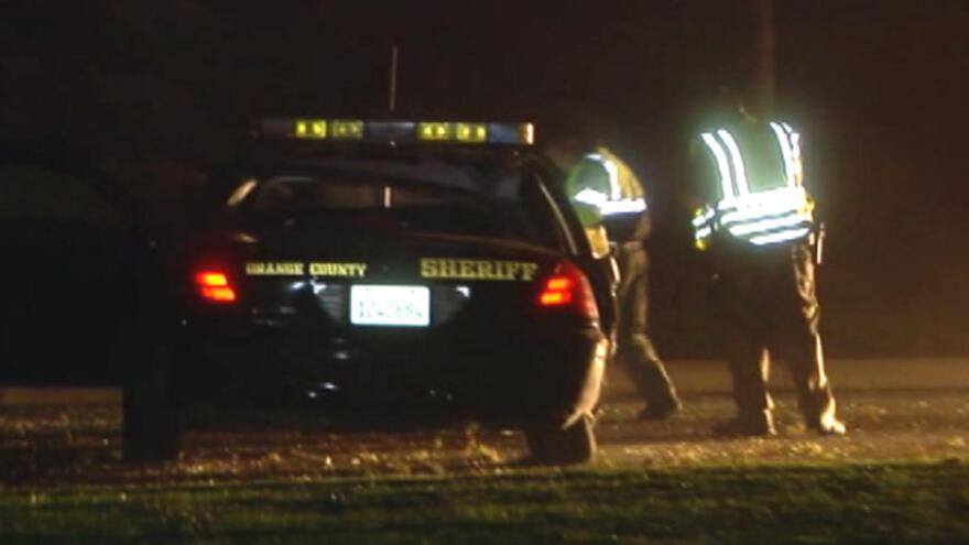 Investigators at the scene of crash involving an Orange County Sheriff's deputy Monday June 17, 2013.
