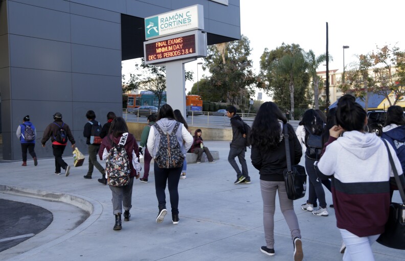 Students arrive at the Ramon C. Cortines School of Visual and Performing Arts in downtown Los Angeles on Wednesday, Dec. 16, 2015. Students are heading back to class a day after an emailed threat triggered a shutdown of the vast Los Angeles Unified School District.