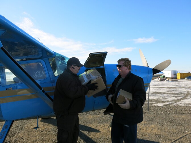 Bush pilot John Bouker (right) and village public safety officer Mike Myers (left) outside Bouker's Cessna 207. Bouker transports Alaskan cops to remote areas and helps pick up prisoners.